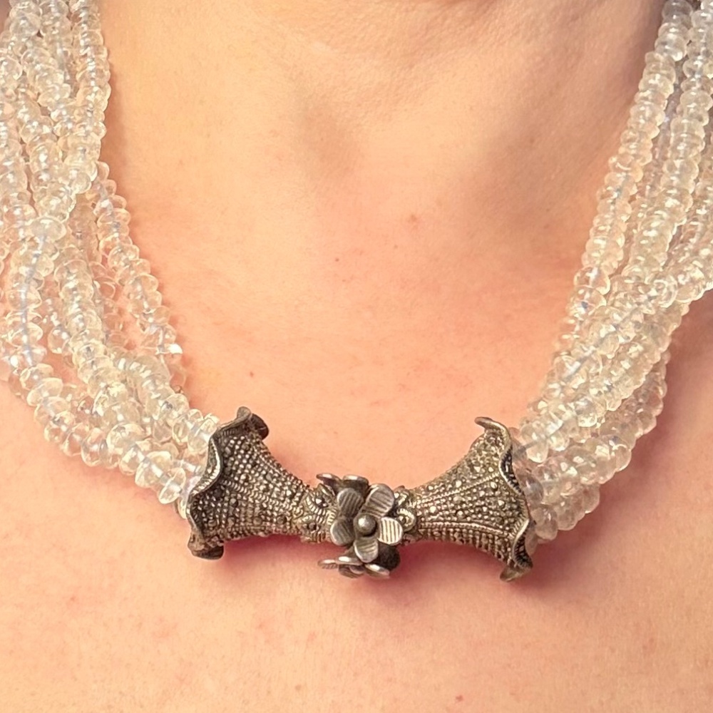 Multi-strand beaded necklace with silver floral detail
